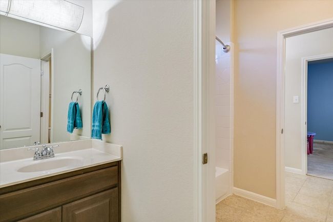 Bathroom set up with 2 separate vanities and 1 tub in between | Image 26