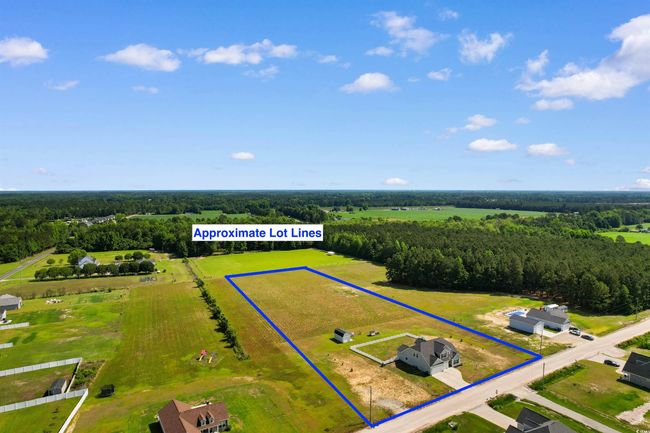 Overview of rural landscape featuring property boundaries highlighted and a heavily wooded area | Image 38