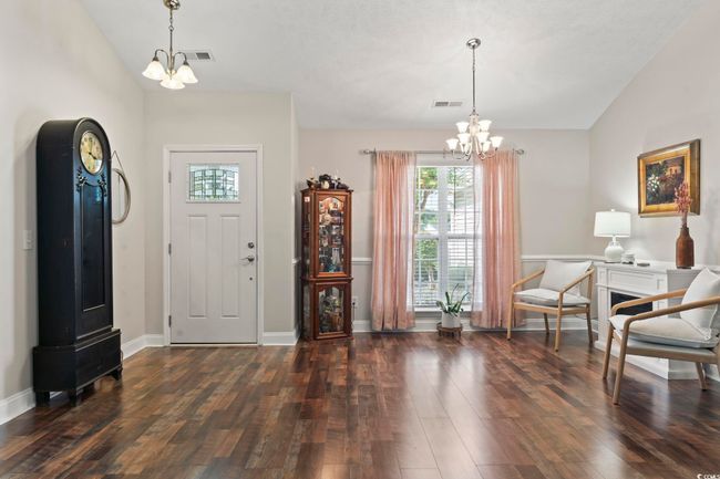 Foyer with a chandelier, wood-type flooring, and vaulted ceiling | Image 11