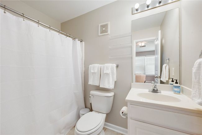 Full bathroom with visible vents, ensuite bath, toilet, and vanity | Image 11