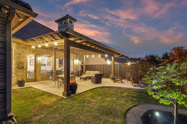 Yard at dusk with a patio area, fence, and an outdoor living space | Image 34