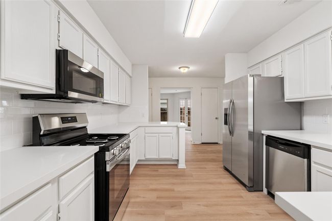 Efficient design with modern appliances, ample counter space, and classic cabinet styling. | Image 11