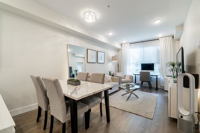 Dining room with dark wood-type flooring and baseboards | Image 6