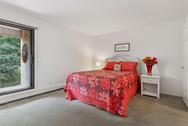 Primary bedroom with direct access to a covered balcony, ideal for morning coffee or evening relaxation | Image 7
