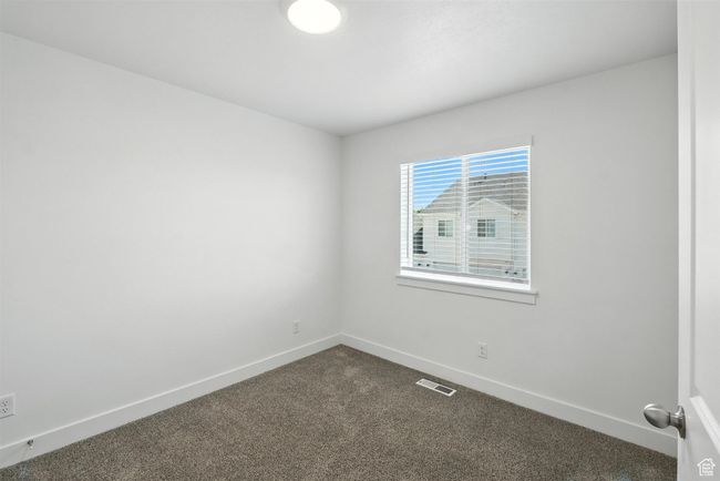 Spare room with dark colored carpet and baseboards | Image 11