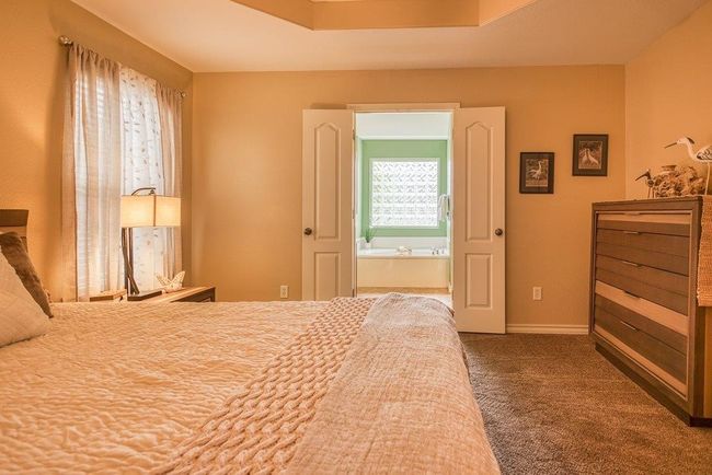 Double French doors lead to the primary bath | Image 22