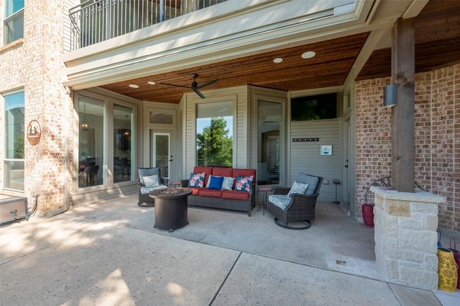 Patio / terrace featuring an outdoor living space with a fire pit, a patio, and a ceiling fan | Image 10