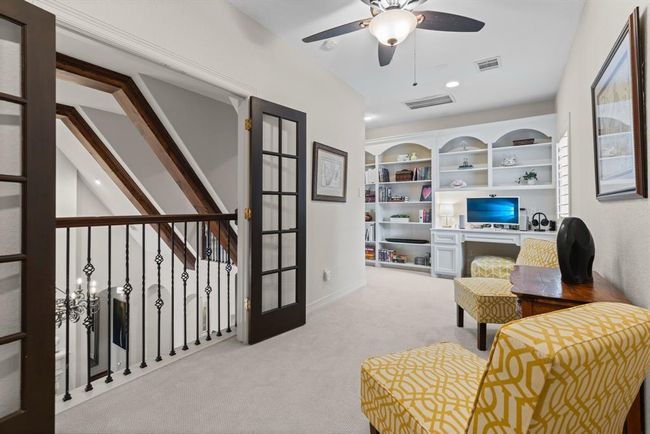 There is an upstairs library room with a built-in desk and reading chairs. This space would also make a perfect game room or shuffleboard nook... | Image 41