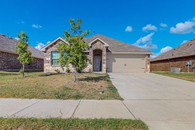 View of front of home featuring a garage, central AC, and a front yard | Image 2