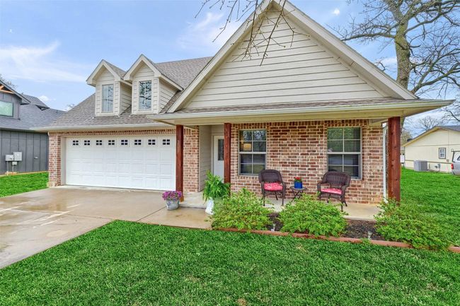 View of front of property with driveway, a front yard, and brick siding | Image 4