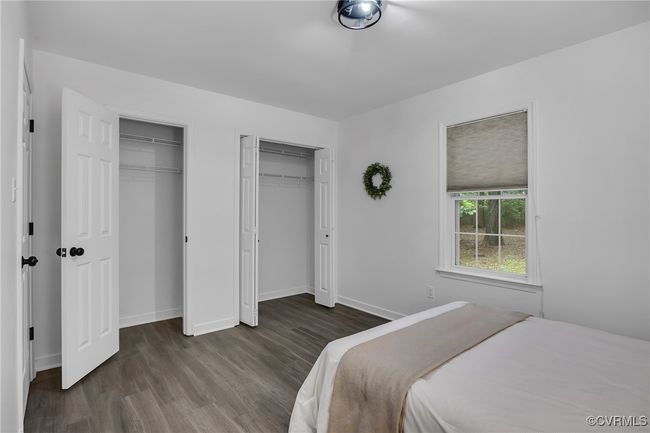 Bedroom featuring multiple closets, wood finished floors, and baseboards | Image 17