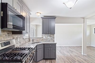 kitchen is open to a second living or dining space | Image 3