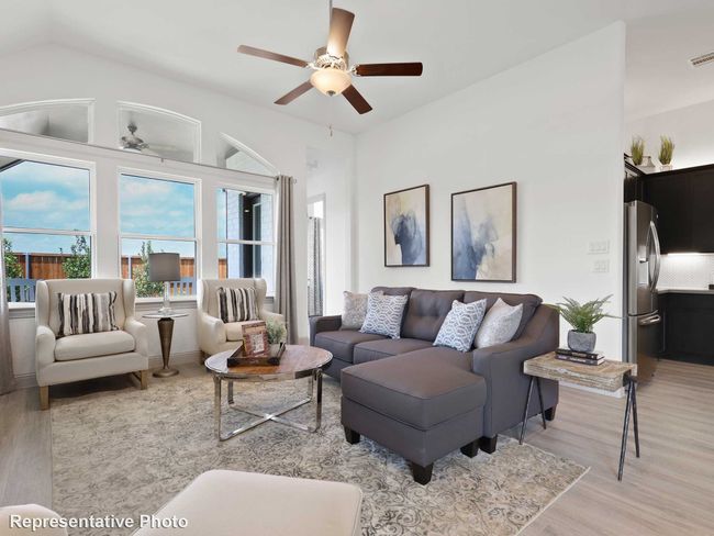 Living room with a ceiling fan, visible vents, and light wood-style flooring | Image 5