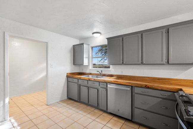 Kitchen featuring dishwasher, gray cabinets, butcher block countertops, and range | Image 7
