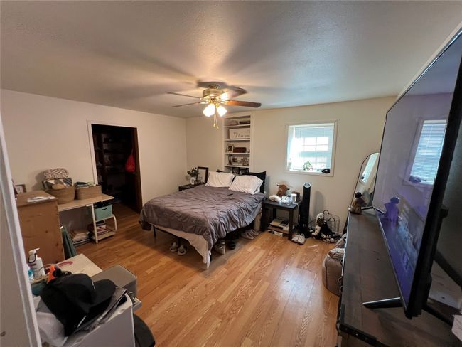 Bedroom featuring light wood finished floors and ceiling fan | Image 18