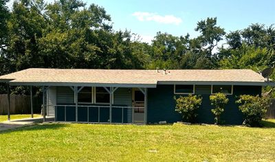 Ranch-style home featuring a carport and a front yard | Image 1