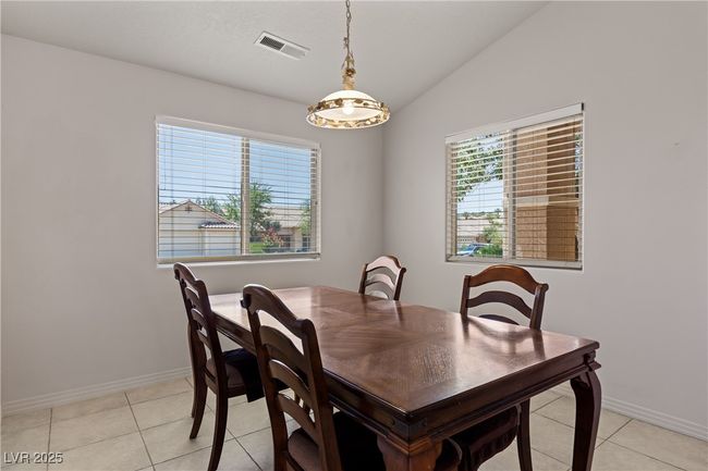 Dining area featuring lofted ceiling and light tile patterned floors | Image 18