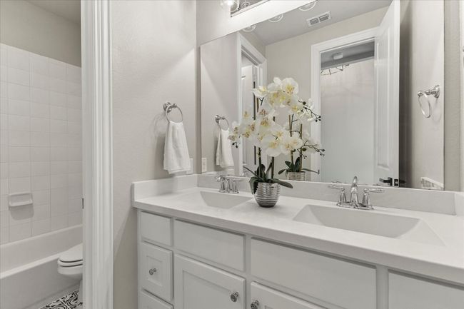 Bathroom featuring dual sinks and shower / tub combo | Image 6