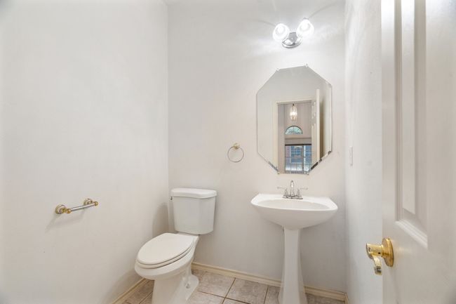 Half bath featuring toilet, tile patterned flooring, and baseboards | Image 14