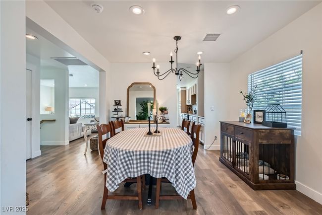 Dining room featuring a chandelier, wood finished floors, baseboards, and recessed lighting | Image 9
