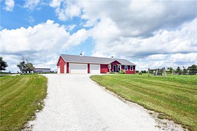 Single story home featuring a garage and a front yard | Image 1