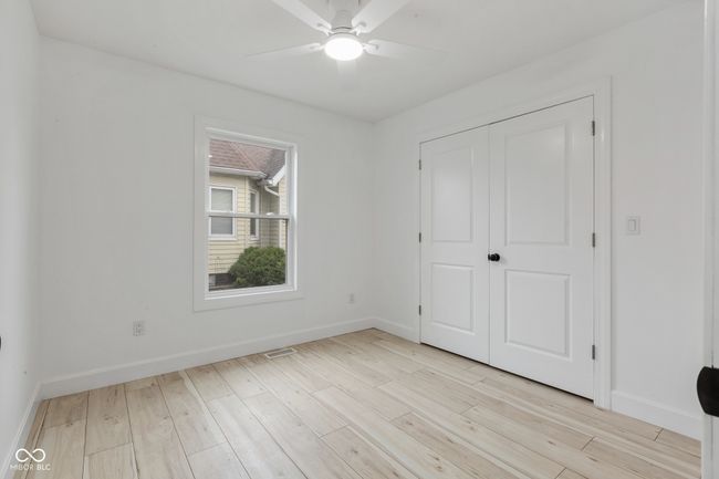 unfurnished bedroom with visible vents, a closet, baseboards, a ceiling fan, and light wood-style flooring | Image 37