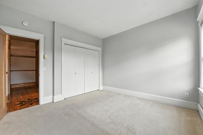 Bedroom with large closet and easy hallway access, highlighted by original trim work. | Image 20
