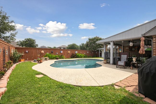 View of pool featuring a patio, ceiling fan, and area for grilling | Image 31