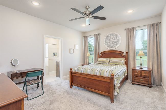Spacious and private primary suite is tucked at the back of the home. | Image 16
