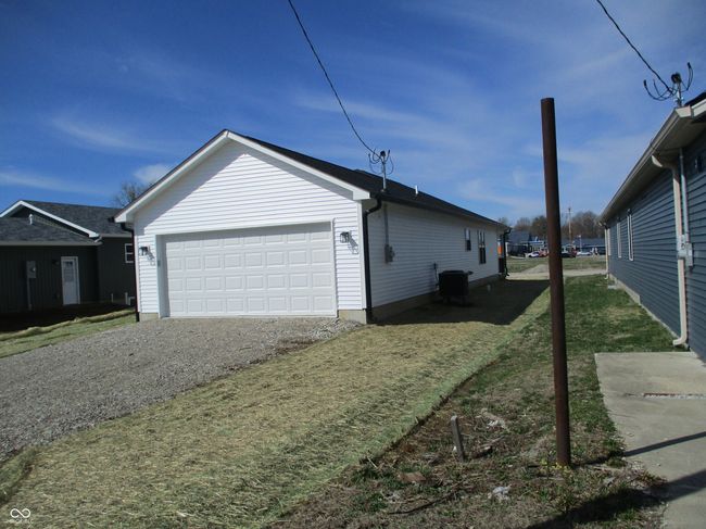 view of home's exterior featuring cooling unit and a garage | Image 22