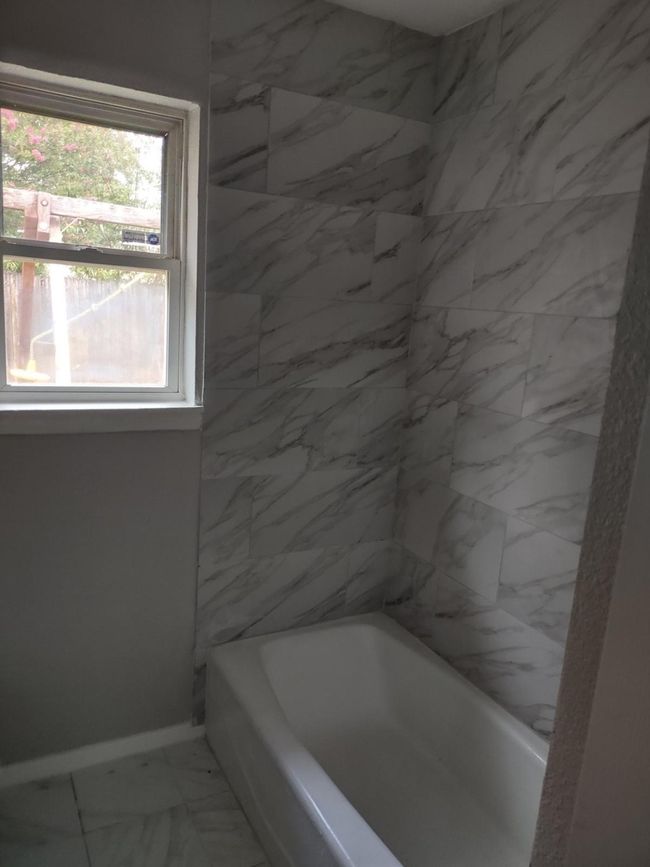 Bathroom with marble look tiles and shower combination | Image 11