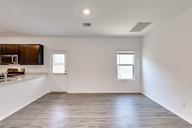 Unfurnished dining area with plenty of natural light, light wood finished floors, and baseboards | Image 14