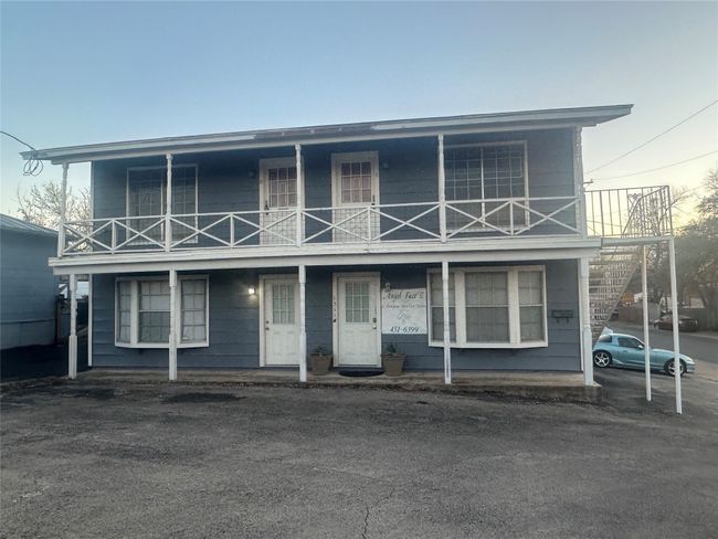 Townhome / multi-family property featuring a balcony and covered porch | Image 10