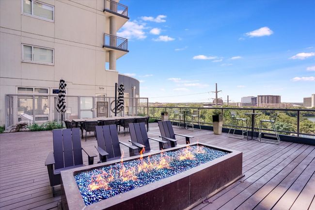 Wooden deck with a fire pit and outdoor dining area | Image 20