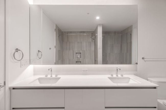 Full bathroom featuring double vanity, toilet, and a sink | Image 13