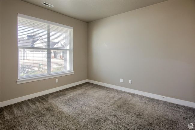 Spare room featuring carpet flooring, baseboards, and visible vents | Image 18