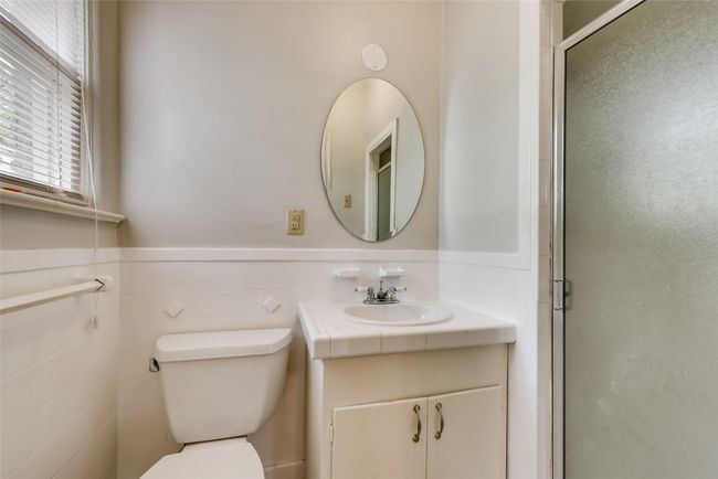 Bathroom featuring vanity, a shower stall, and a wainscoted wall | Image 24