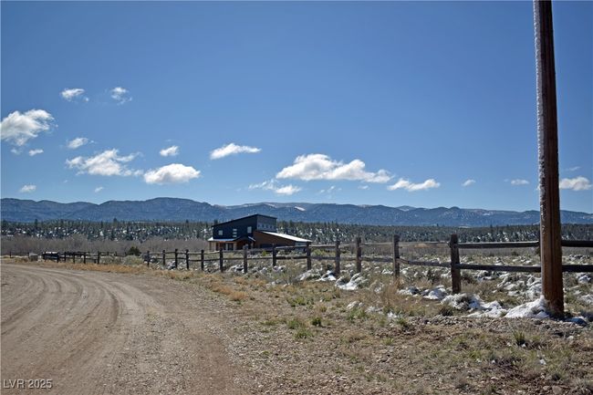 View of mountain backdrop featuring rural landscape | Image 5