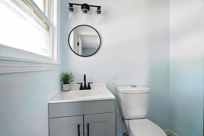 Half bathroom featuring healthy amount of natural light and vanity | Image 14