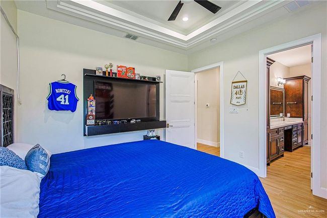 Bedroom with a tray ceiling, porcelain floor, and ceiling fan, with jack and Jill bathroom | Image 28