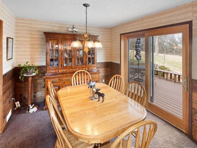 The formal dining room opens to a cozy deck—perfect for relaxing or entertaining. | Image 11