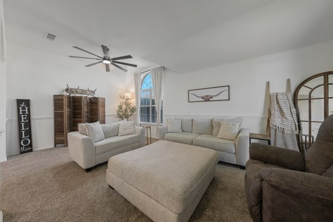 Living area featuring ceiling fan, carpet, and baseboards | Image 5