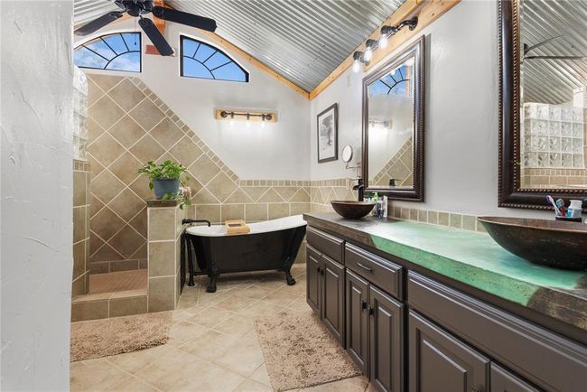 Full bathroom with lofted ceiling, a sink, a ceiling fan, and tile walls | Image 17