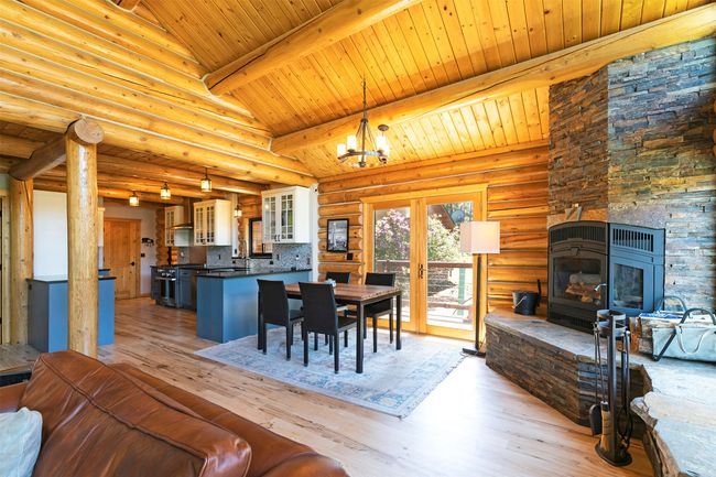 Dining room with wooden ceiling, light wood-style flooring, french doors, and a chandelier | Image 15