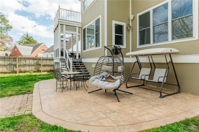 View of patio featuring stairs, fence, and outdoor dining space | Image 45
