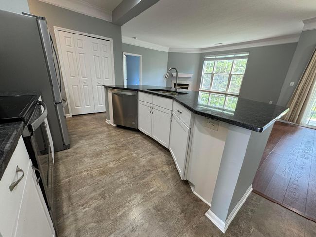 Open kitchen with granite countertop, under mount sink and newer SS appliances | Image 11