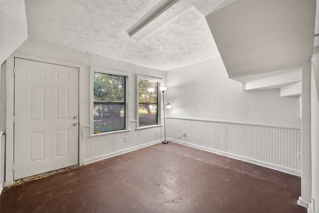 Entryway featuring concrete flooring and wainscoting | Image 5