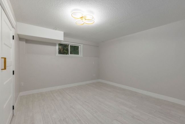 Empty room featuring light wood-style floors, a textured ceiling, and baseboards | Image 34