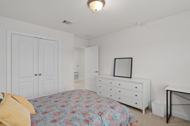 Bedroom with a closet and light colored carpet | Image 25