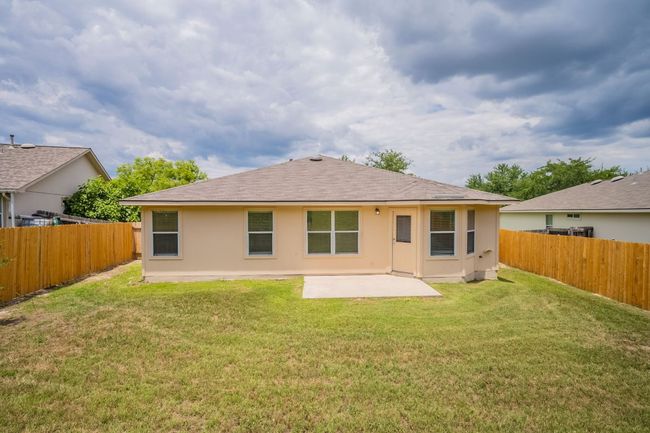 Rear view of property featuring stucco siding, a patio, and a shingled roof | Image 32